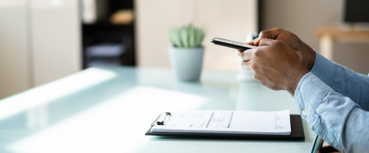 You can see someone scanning a document with an app on his phone.