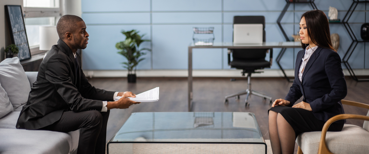 Typical scene from a job interview, where a male human resource manager sits across an applicant talking about the job.