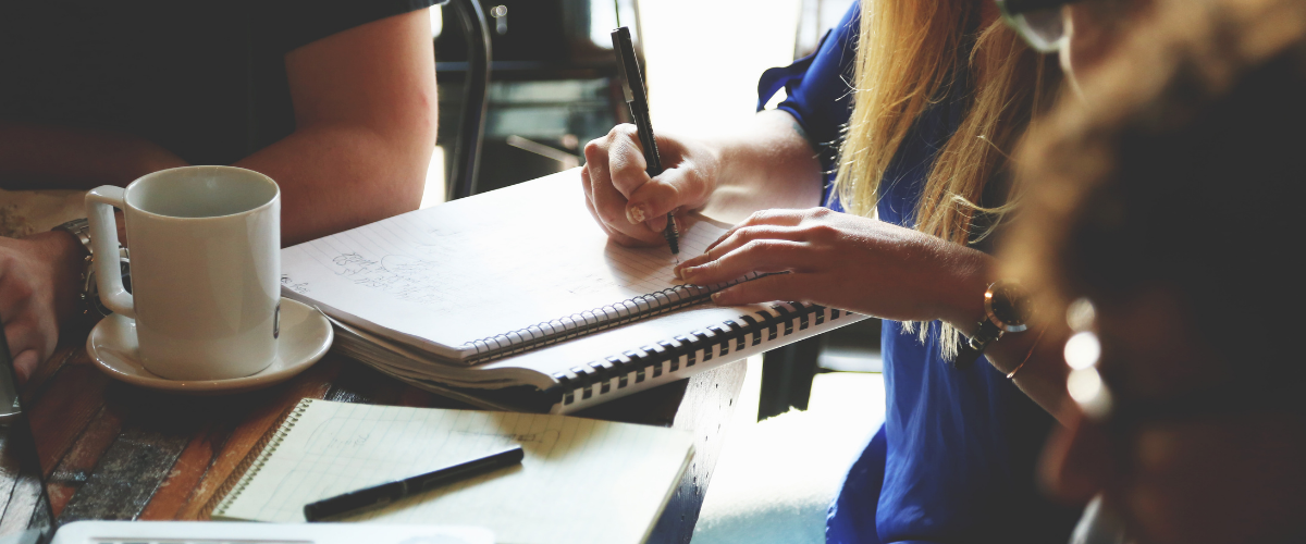 Work colleagues sit together an talk/brainstorm about ways to improve their HR process.